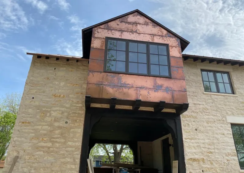 Copper metal panel facade on a stone building for Roof Repair in DeFuniak Springs