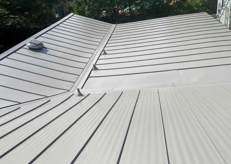 Solar attic fan installed on a metal roof for Roof Ventilation in DeFuniak Springs